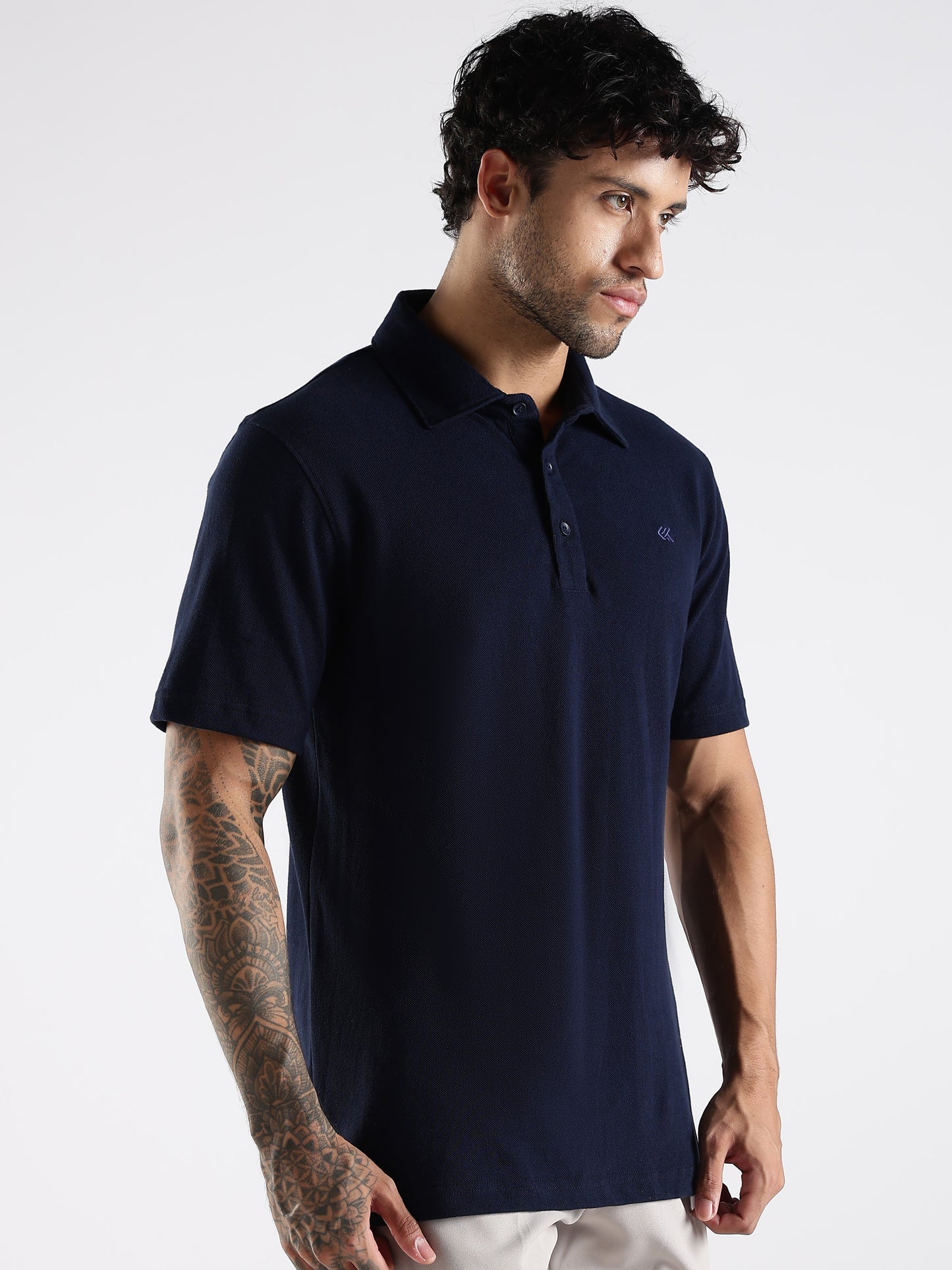 Navy blue polo shirt with 3-button placket and a smart embroidered brand logo on a white background.