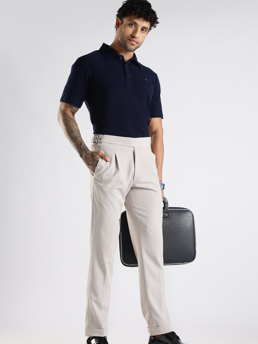 Man wearing a navy polo shirt and beige pants holding a black briefcase on a white background. Perfect for events and gifts.