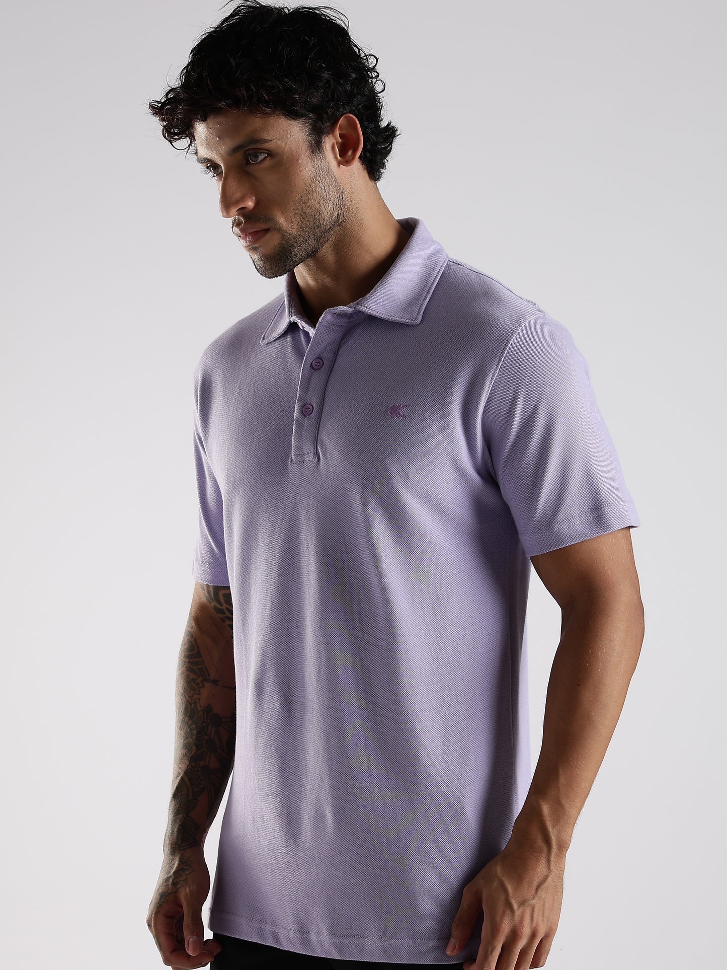 Man wearing a light Lavender polo shirt against a plain background