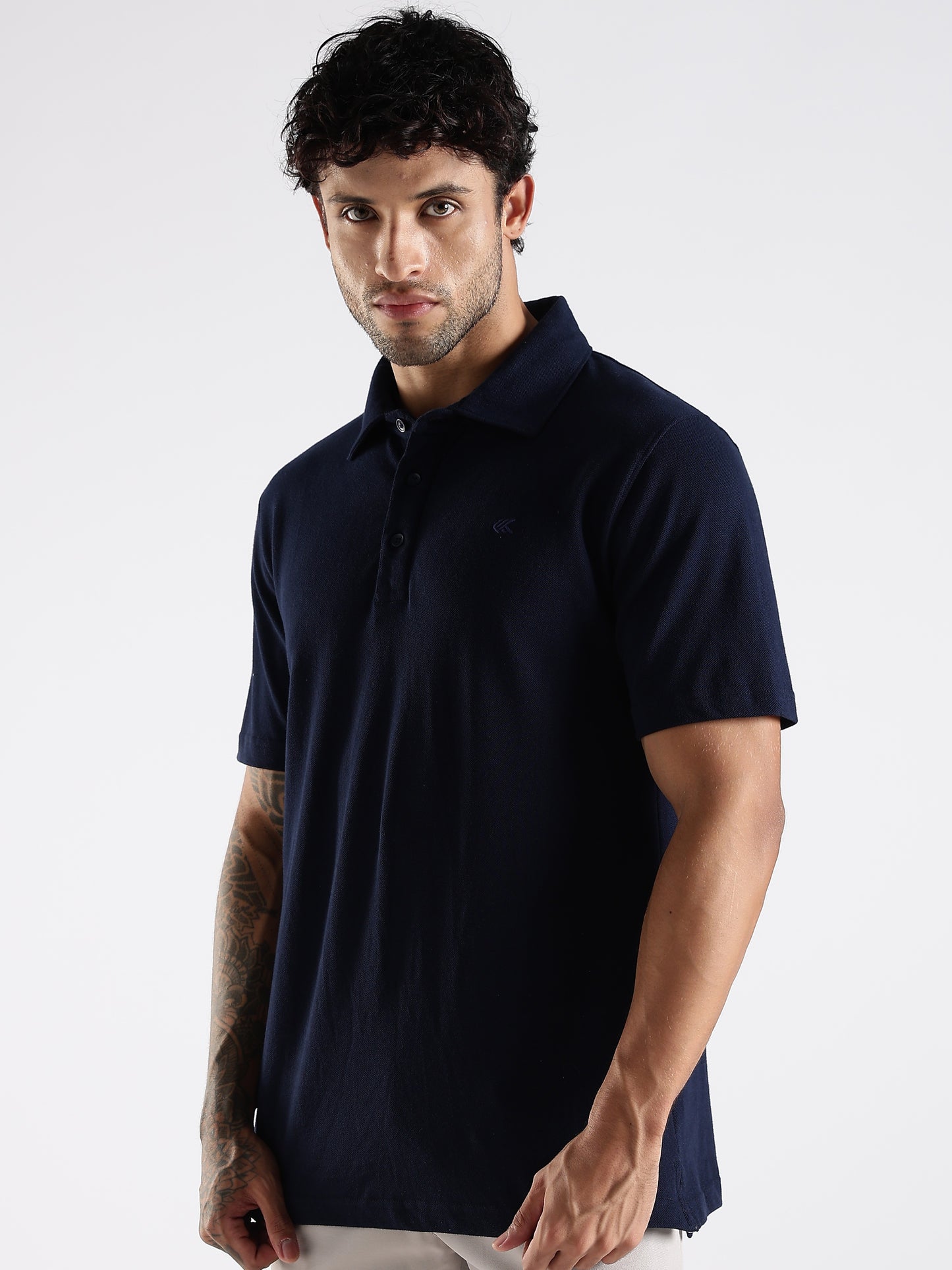 Man wearing supersoft and smooth Solid Pattern navy blue polo t-shirt against a white background.
