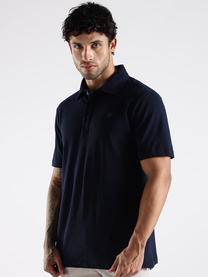Man wearing supersoft and smooth Solid Pattern navy blue polo t-shirt against a white background.