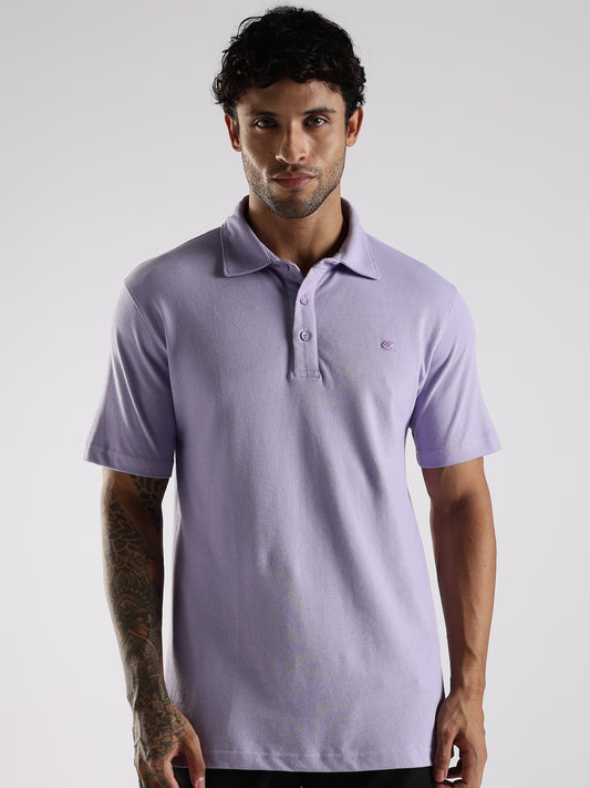 Man wearing a light purple polo shirt on a white background